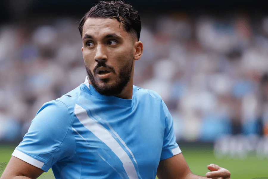 Portrait de Ryan Cherki célébrant un but avec ses coéquipiers, symbole de son succès à Manchester City.